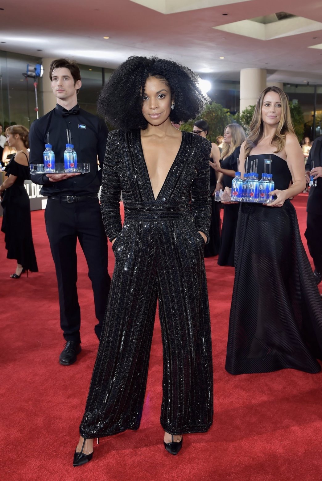 Golden Globe Awards 18 - Susan Kelechi Watson wearing a Monsoori jumpsuit, NeilJ. Rodgers shoes, a Tyler Ellis clutch, and jewelry from Harry Kotlar & Narcisa Pheres via Getty Images Susan Kelechi Watson wearing a Monsoori jumpsuit, NeilJ. Rodgers shoes, a Tyler Ellis clutch, and jewelry from Harry Kotlar & Narcisa Pheres.