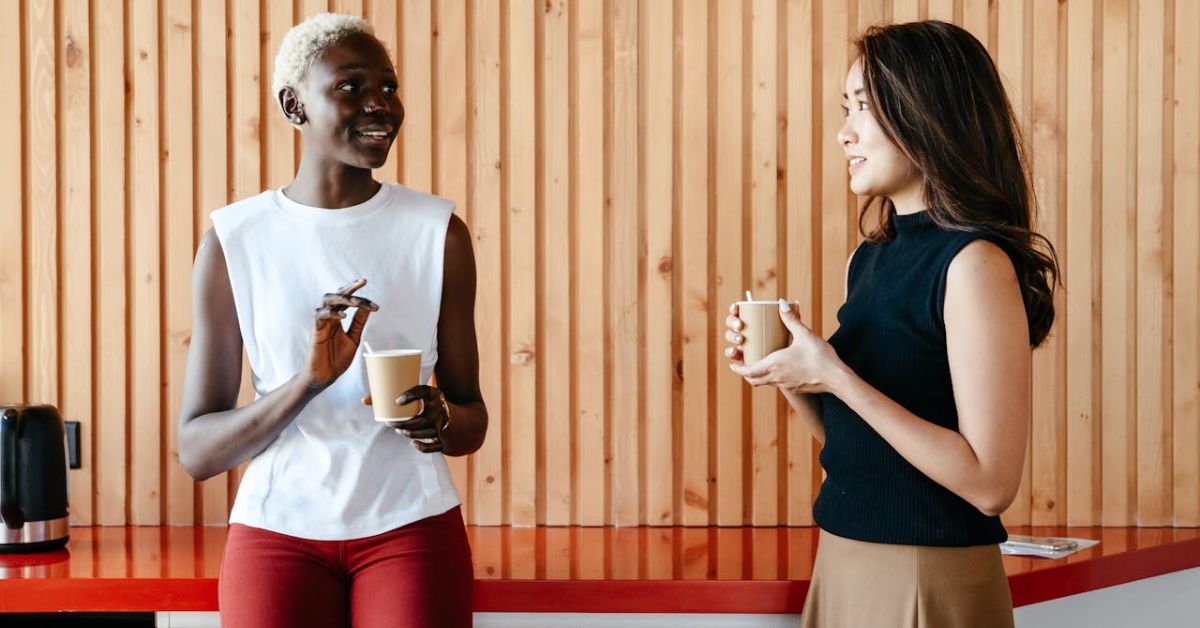 two women having coffee and talking together