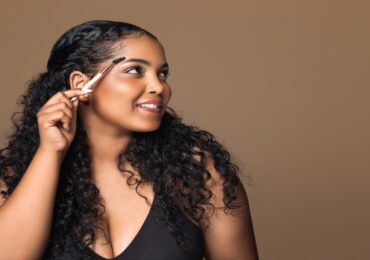 African American woman showing tips for perfect eyebrows