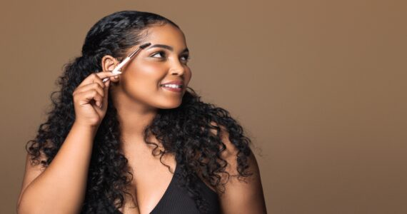 African American woman showing tips for perfect eyebrows