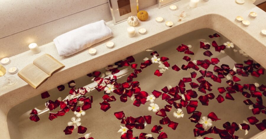 Spa bath with candles and rose petals