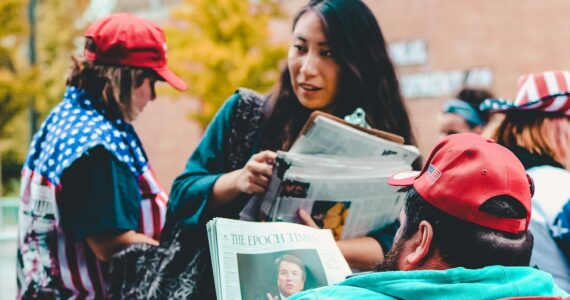 woman holding newspapers