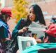 woman holding newspapers