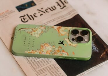 a smartphone and a newspaper