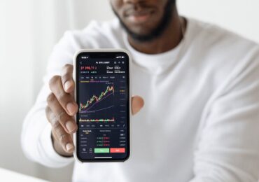 man holding black smartphone