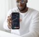 man holding black smartphone
